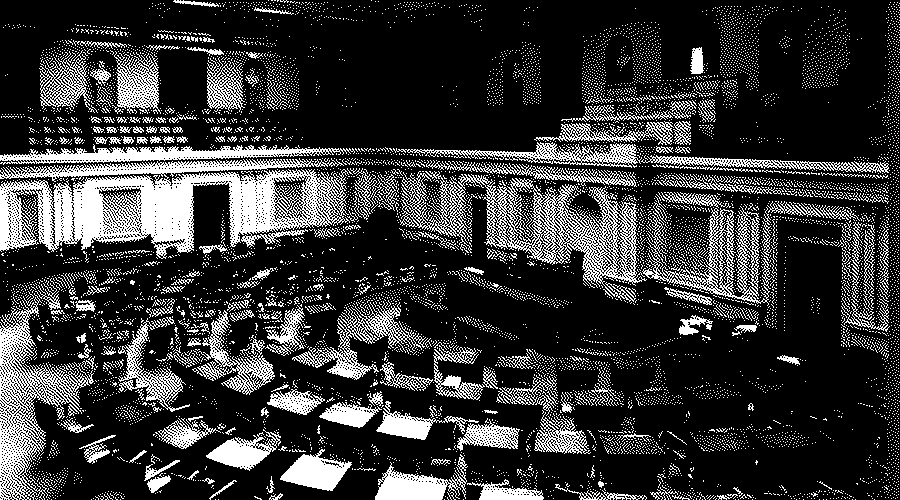 The Senate chamber seen from the gallery, with semicircular rows of wooden desks facing the presiding officer's desk.