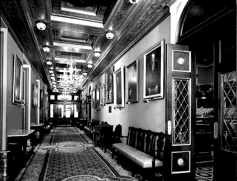 A long gilded hallway with a patterned carpet, a coffered painted ceiling, crystal chandeliers and framed portraits on the wall, and an open door at the right onto a legislative chamber.