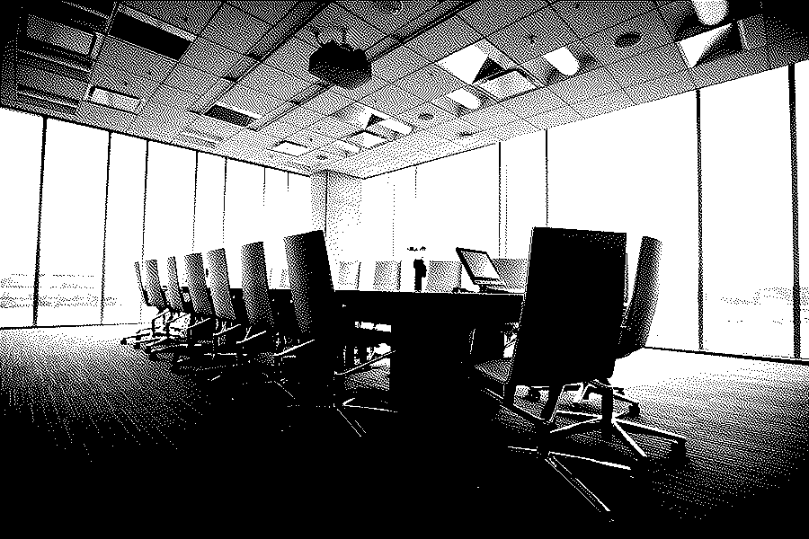An empty boardroom with a long wooden table and leather chairs in front of floor-to-ceiling windows