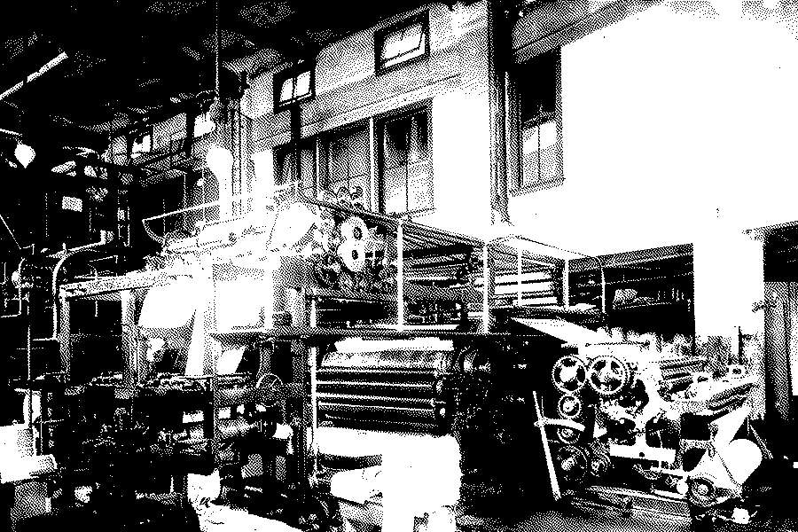Rotary printing presses, gears and paper rolls in the press room of the New York Herald in 1902
